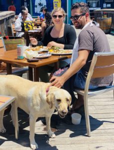 A couple with their dog eating at Fog Harbor Fish House