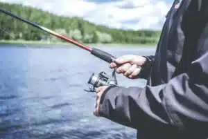 Person with a fishing rod near water